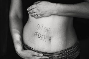 woman with out of order written on her stomach