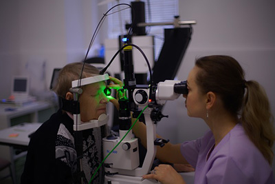 person getting eye checked by eye doctor