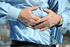 man holding stomach because of pain