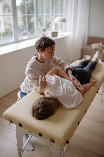 chiropractor tending to patient on table