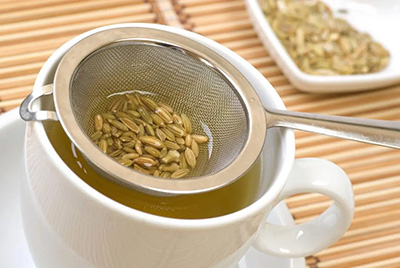 tea cup and strainer of fennel seeds and tea