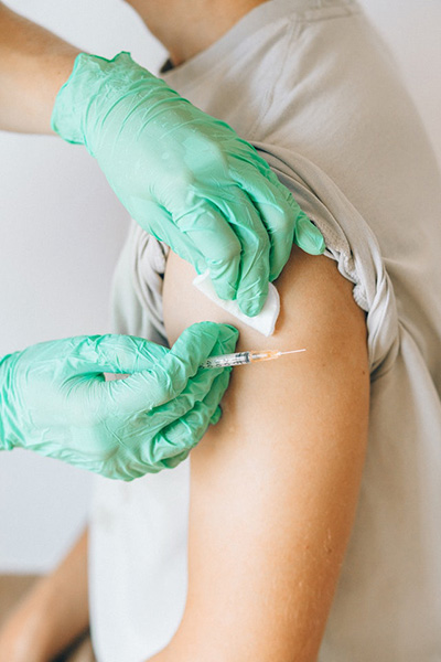 health practitioner preparing to give patient injection