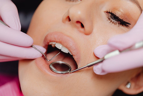 woman getting teeth checked