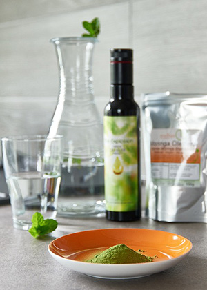 herbal powder in a plate and oil in a bottle