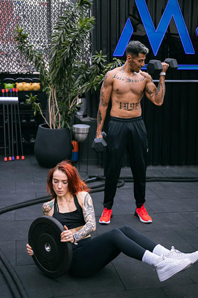 man and woman putting in work at the gym