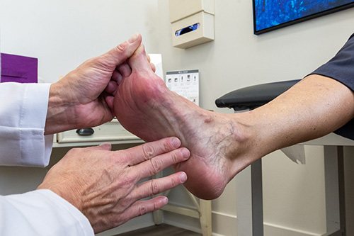 podiatrist tending to patients feet