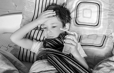 a sick child holding an asthma inhaler