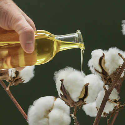 cottonseed oil being poured on cotton