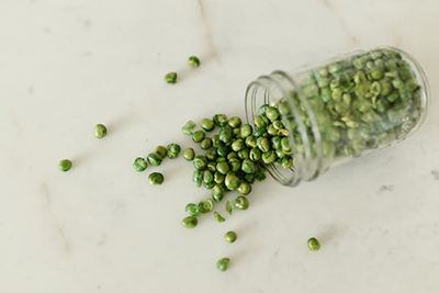 glass jar filled with green peas