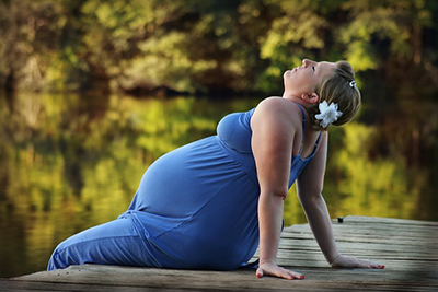 pregnant woman relaxing by the lake