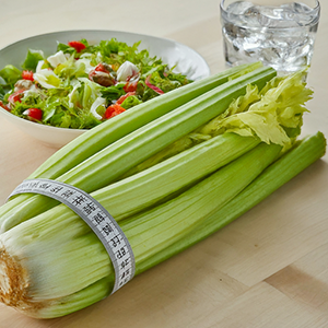 a stalk of celery with a measuring tape around it