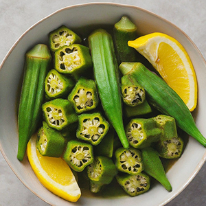 bowl of cooked okra with lemon