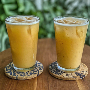 two glasses of peach palm beverage
