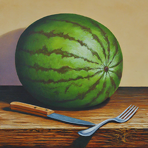 uncut watermelon next to fork and knife