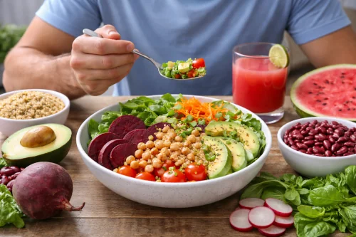 Person eating a variety of nitric oxide foods at a table.
