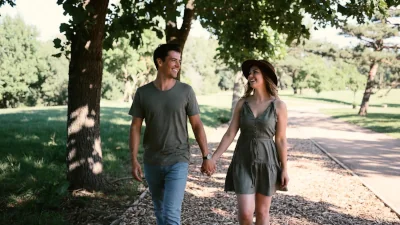 couple taking a memorable walk in the park and learning about what lowers nitric oxide levels.